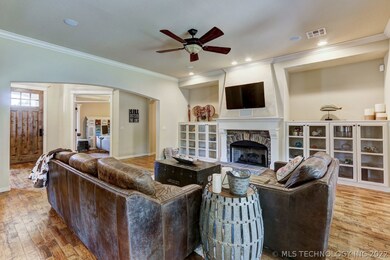 Great room has a cozy fireplace flanked by craftsm