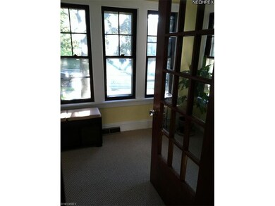 Sun room/Office with carpet and beautiful original woodwork!