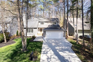 View of property with a garage and a front lawn