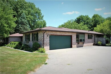 2-Car Attached garage and view of walkway that lea