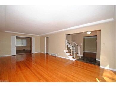 EXPANSIVE LIVING ROOM WITH WOOD FLOORING AND LARGE