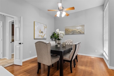 Dining area with light wood finished floors and ceiling fan