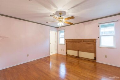 Bedroom is just off the kitchen and has electric storm shutters.  Blinds throughout plus hardwood floors and ceiling fans.  Double size closet plus additional built in shelving and an additional closet in bedroom behind the door.  Each room has wood moulding top and bottom.