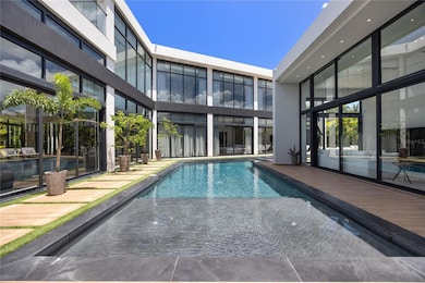 Every room is thoughtfully positioned around a serene central courtyard oasis, complete with a pool, jacuzzi, outdoor lounge area, and covered terrace with built-in BBQ—perfect for effortless entertaining and relaxed gatherings.