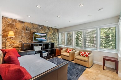 Living room with recessed lighting and light tile