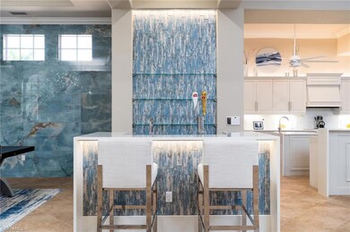 Dining room featuring ornamental molding, light tile patterned floors, ceiling fan, and tile walls