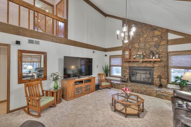 Living room with high vaulted ceiling, a fireplace