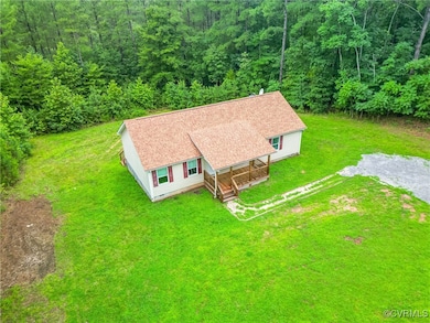 View of subject property with a forest