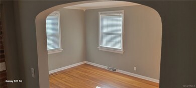Family room featuring light wood-type flooring, crown molding, and plenty of natural light, new paint.