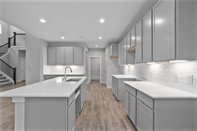 This kitchen is by far any chef’s dream! This spacious kitchen features high ceilings, stained wood cabinets, quartz countertops, SS appliances, modern tile backsplash, recessed lighting, extended counter space, granite kitchen island with space for breakfast bar, and a walk-in pantry all overlooking your huge family room.