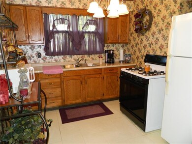 Unit 104 kitchen. Gas stove and refrigerator.