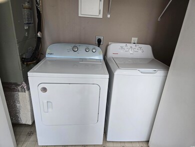 Laundry area featuring washing machine and dryer and heating unit