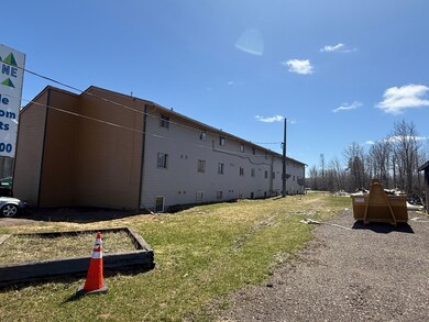 View of side of home featuring a yard