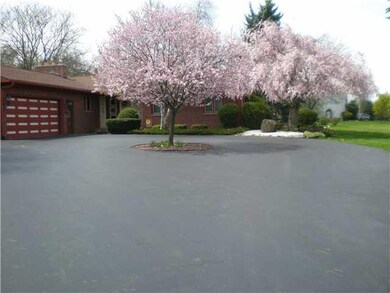 Exterior Front Wonderful colors of flowering trees adorn the front of this custom built ranch