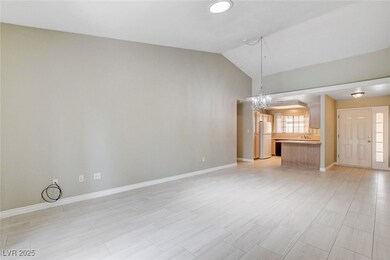 Unfurnished living room with a chandelier and loft
