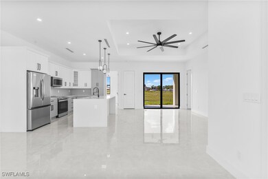 Kitchen with a tray ceiling, light countertops, ap