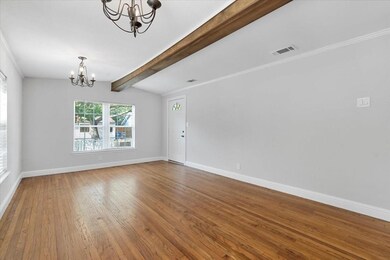 Spare room featuring vaulted ceiling with beams, o
