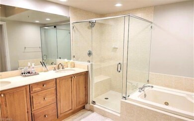 Bathroom with a whirlpool tub, double vanity, a shower stall, and recessed lighting