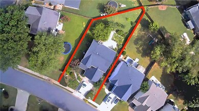 Aerial perspective of suburban area featuring property parcel outlined