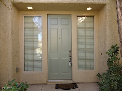 Entrance to property featuring stucco siding