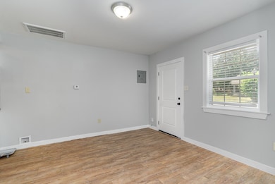 Spare room with light wood-style floors and electric panel