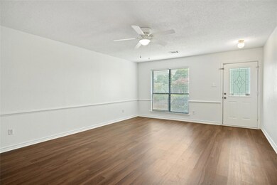 Living room offering a  ceiling fan, and hardwood 