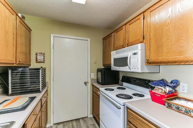 Kitchen featuring light wood-type flooring, white 