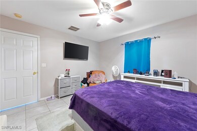 Bedroom with tile patterned floors, ceiling fan, a