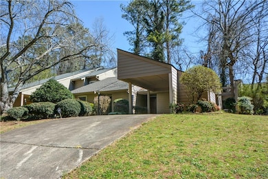 Mid-century home with a front yard, concrete drive