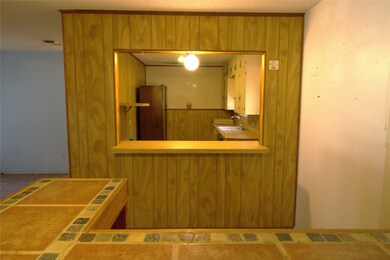 Standing at moveable bar looking into the kitchen.
