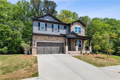 Craftsman inspired home with a garage, driveway, s