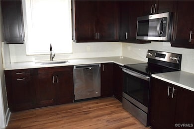 Kitchen with stainless steel appliances, a sink, w