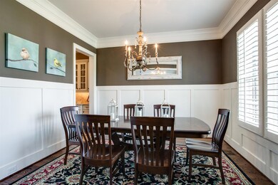 A gorgeous set of windows overlooks the front yard, every element of this room combines to help create a space that is both inviting and wonderfully hospitable.