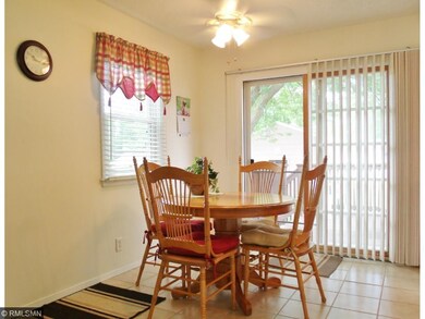 The bright and sunny dining area has a patio door 