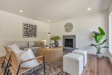 Fresh interior paint, recessed lighting, and a wood burning fireplace.