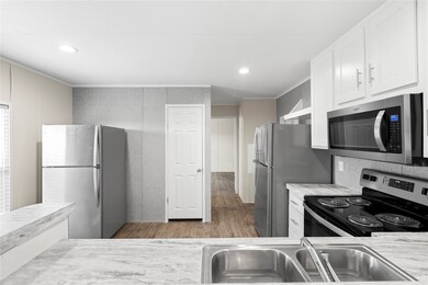 Kitchen area- second refrigerator on the left is n