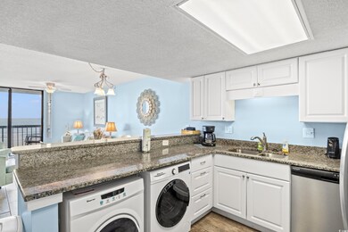 Washroom with sink, washer and clothes dryer, ceil
