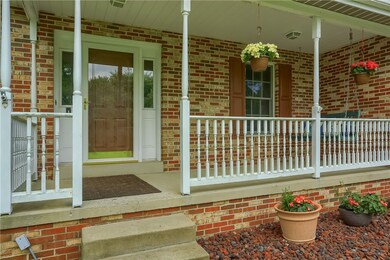 The covered front porch is a wonderful place to ga