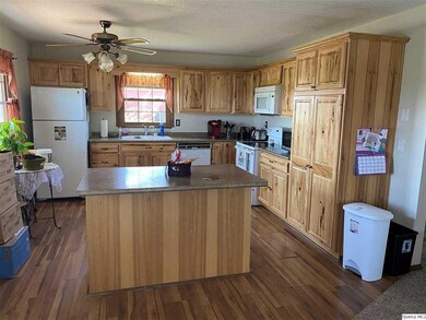 Kitchen has large island and an abundance of Hicko