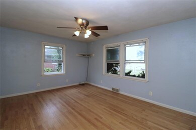 Spare room featuring ceiling fan, light hardwood / wood-style flooring, and plenty of natural light