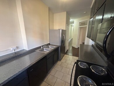 Kitchen featuring light tile flooring, stainless s
