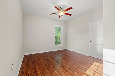 Unfurnished room featuring baseboards, ceiling fan