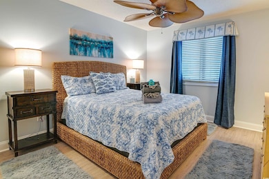 Bedroom with wood finished floors, baseboards, and ceiling fan