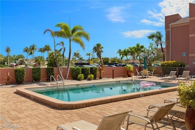 Community pool with fence and a patio