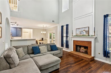 Living area featuring hardwood floors, two-story c