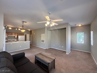 Living area featuring carpet floors, baseboards, a