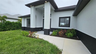 Doorway to property featuring a yard