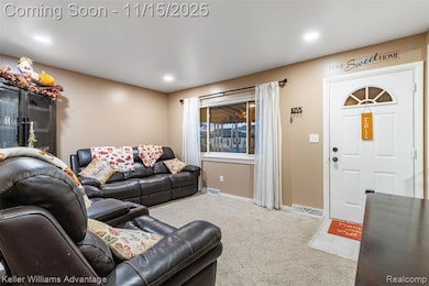 Carpeted living room featuring baseboards and recessed lighting
