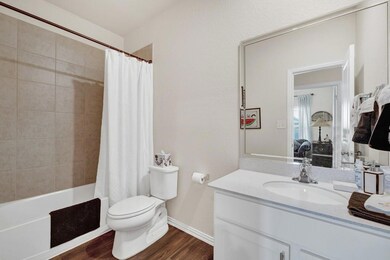 Bathroom featuring vanity, baseboards, toilet, vi