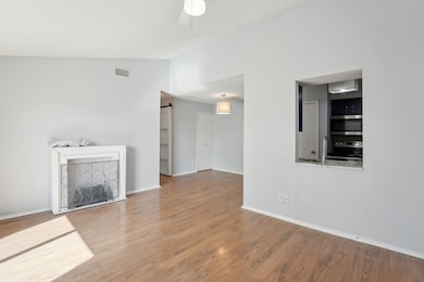 Unfurnished living room featuring lofted ceiling,